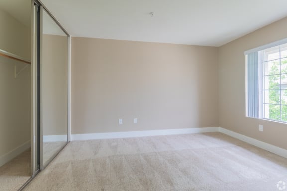 an empty living room with a sliding glass door