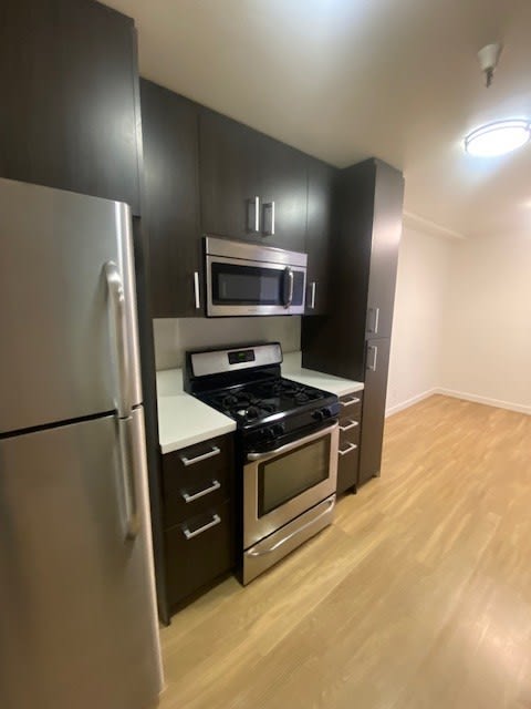 a kitchen with a stove and a refrigerator
