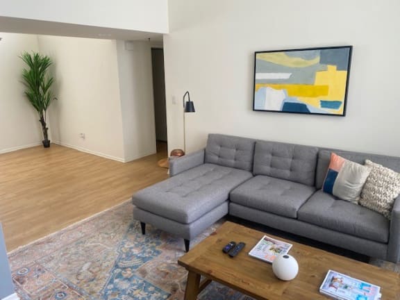 a living room with a gray couch and a table