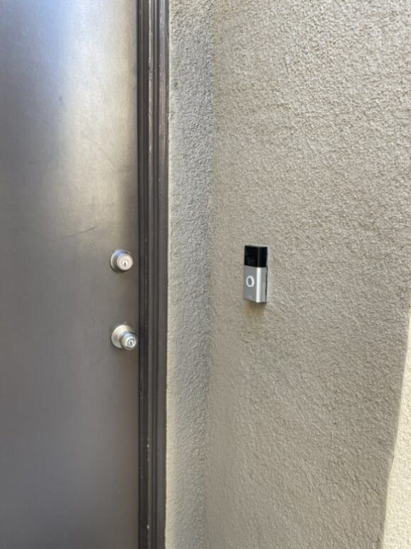 a door with a sensor on the wall