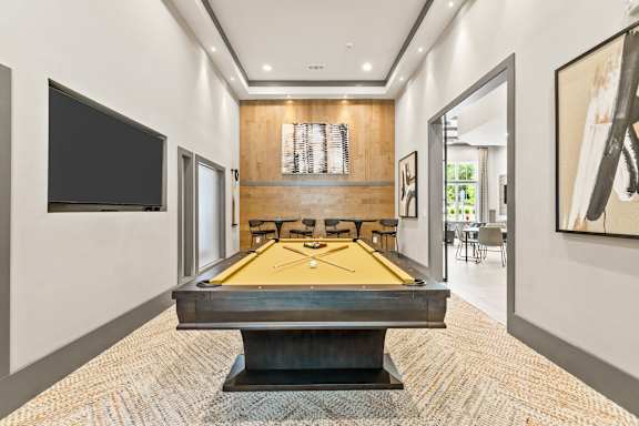 a pool table in a living room with a tv