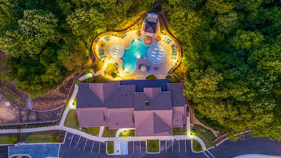 a birdseye view of a house with a pool and trees
