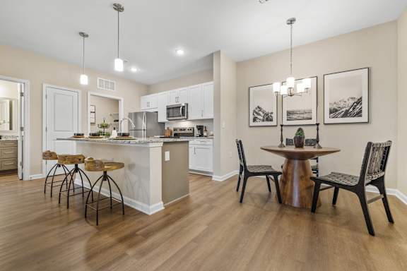 an open kitchen and dining room with a table and chairs