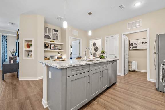 an open kitchen and living room with a large counter top