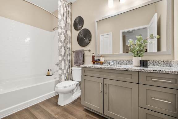 a bathroom with a shower and a toilet and a sink