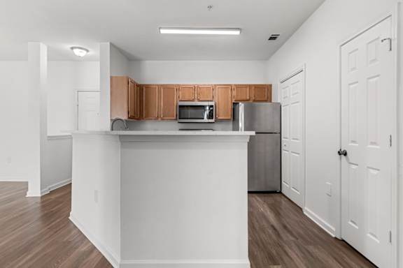A kitchen with white cabinets and a wooden countertop.