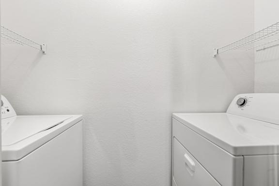 A white bathroom with a toilet and sink.