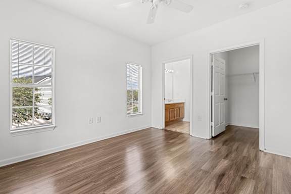 A room with wooden floors and a ceiling fan.
