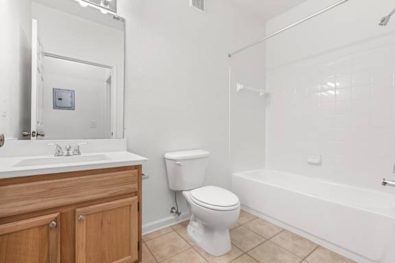 A white toilet sits next to a sink in a bathroom.