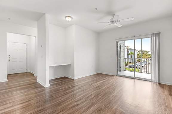A room with a sliding glass door leading to a balcony.