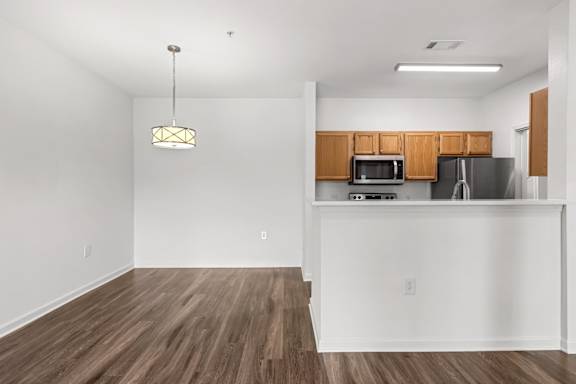 A kitchen with wooden cabinets and a white countertop.