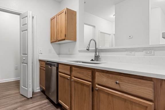 A kitchen with wooden cabinets and a white countertop.