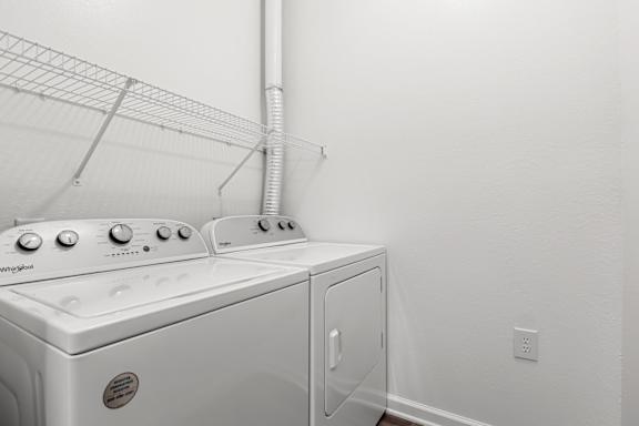 A white dryer and washer in a laundry room.