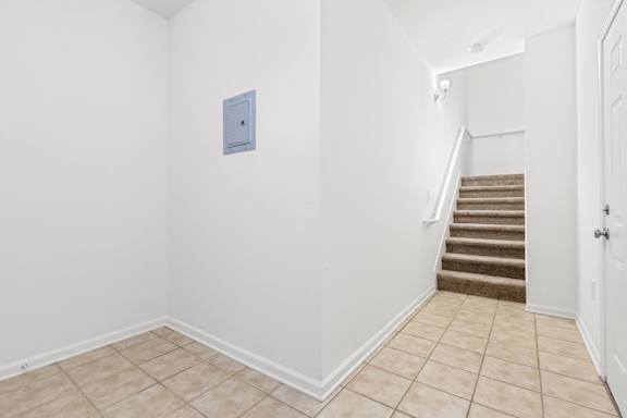 A room with a staircase leading to the next room.