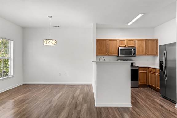 A kitchen with wooden floors and white walls.