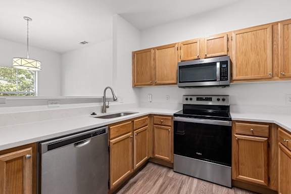 A kitchen with wooden cabinets and stainless steel appliances.