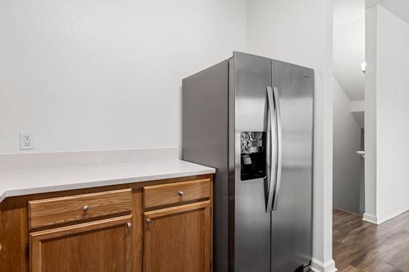 A stainless steel refrigerator with a water and ice maker dispenser on the door.