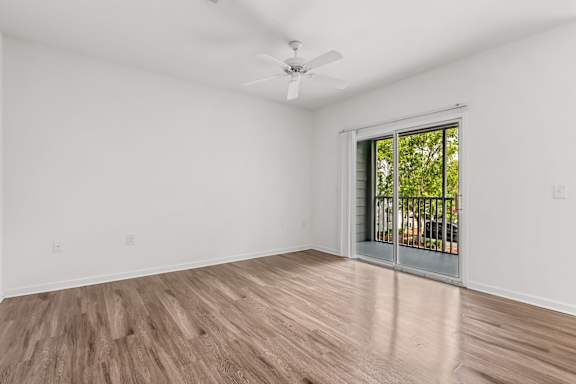 A room with a sliding glass door leading to a balcony.