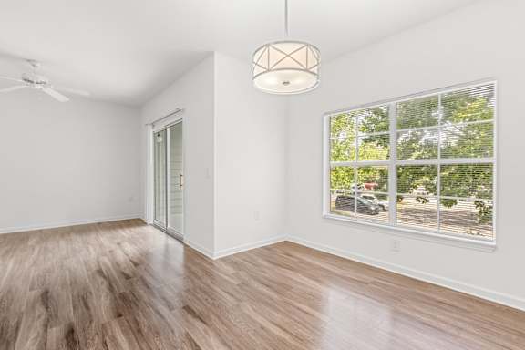 A room with a window and a ceiling fan.