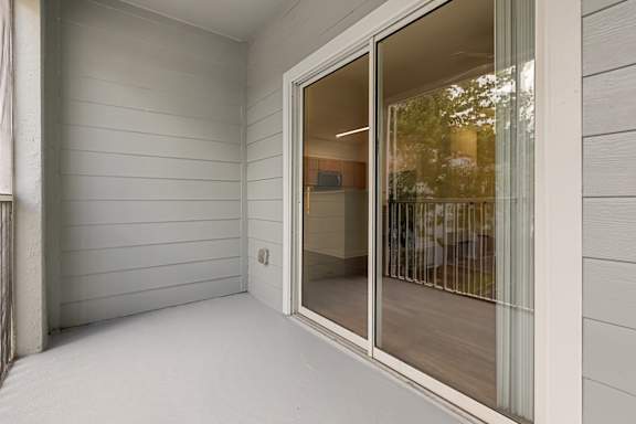 A white room with a sliding glass door.