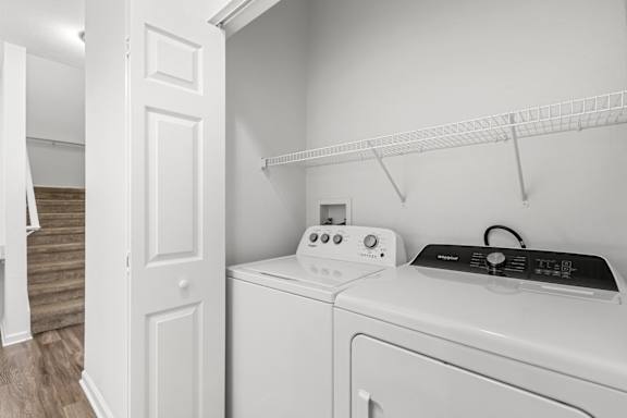 A white washing machine and dryer in a small laundry room.