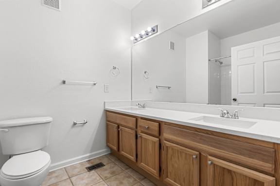 A white toilet sits next to a sink in a bathroom.