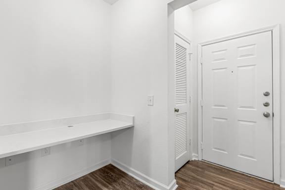 A white door with a white wall behind it.