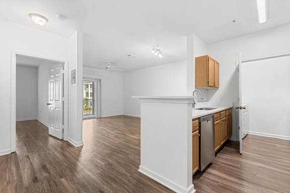 A kitchen with wooden cabinets and a white island.
