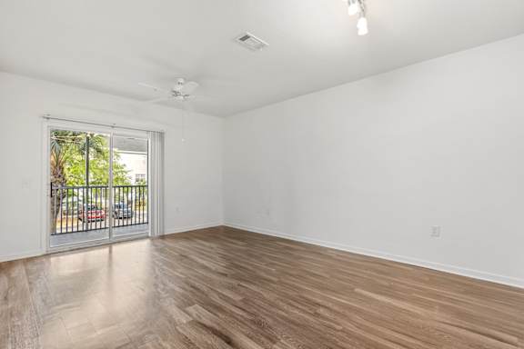 A room with a sliding glass door leading to a balcony.