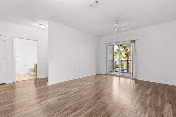 A room with a sliding glass door leading to a balcony.