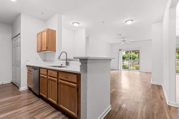 A kitchen with wooden cabinets and a white countertop.