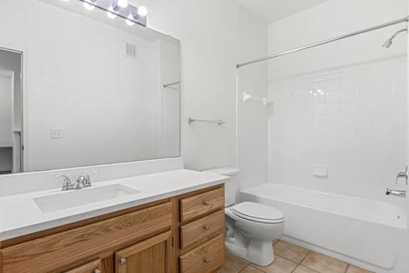 A white bathroom with a sink, toilet, and bathtub.