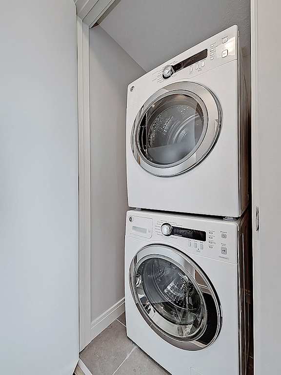 Two white front loading washing machines in a small laundry room.