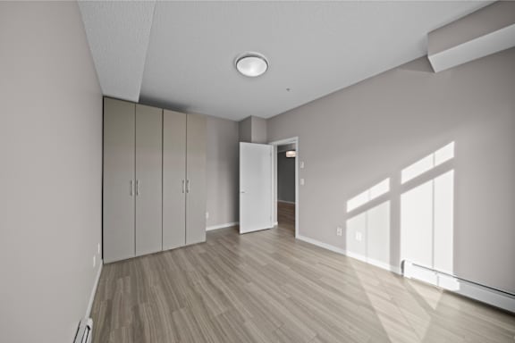 an empty living room with white walls and wood flooring