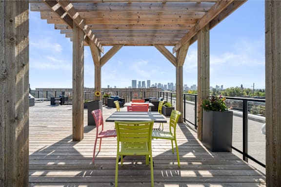 a patio with a table and chairs on a roof