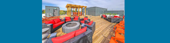 A wooden deck with red and black seating.