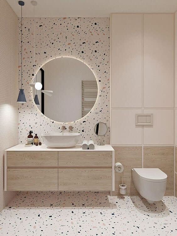 a bathroom with a mirror and a toilet and a sink