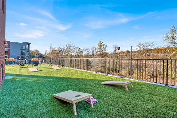 A backyard with a lawn and a trampoline.