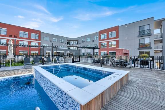 A swimming pool in a courtyard surrounded by apartment buildings.
