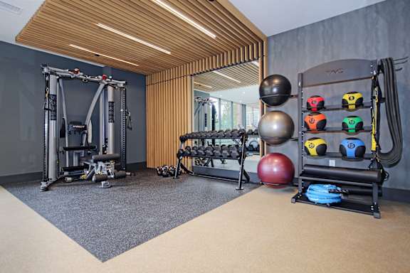 A gym with a variety of equipment including weights and a leg press machine.