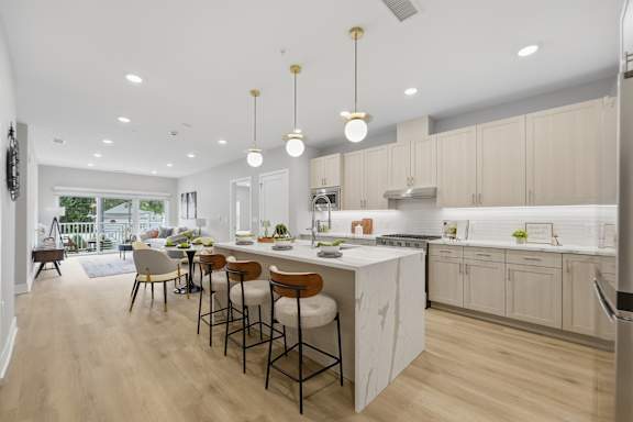 A kitchen with a bar area and a dining table.