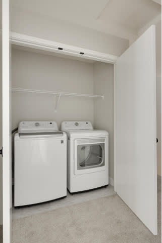 A small laundry room with a washer and dryer.