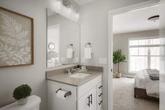 A bathroom with a white sink and a large mirror.