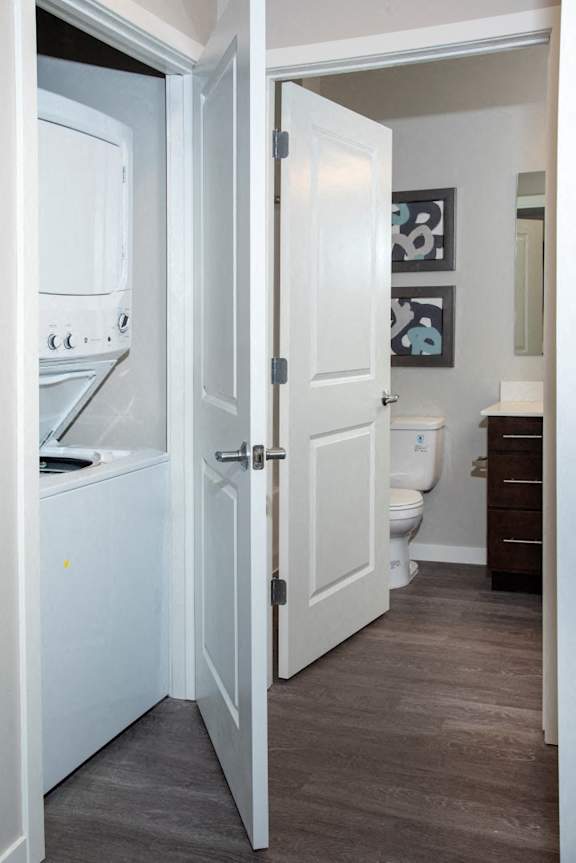 A white door is open to a bathroom.