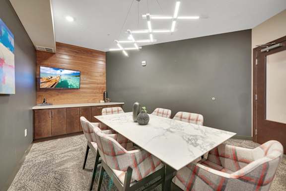 A conference room with a long table and chairs.