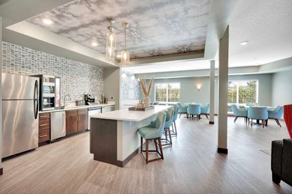 A modern kitchen with a dining area and a refrigerator.