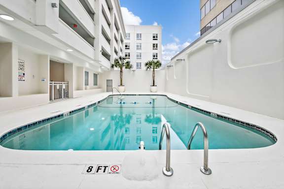 A small indoor pool with a height restriction of 8 feet.
