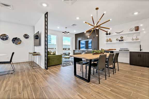 A modern dining room with a wooden table and chairs.