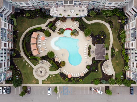 an aerial view of a resort style swimming pool with a lazy river