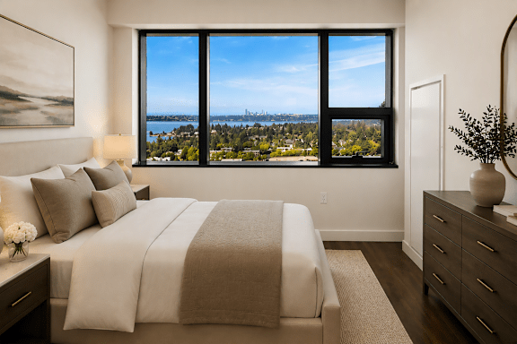 A bedroom with a large bed and a view of the city.